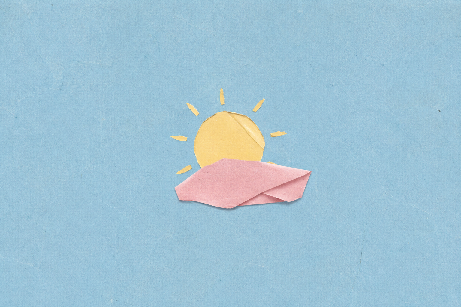 A handmade paper collage of a yellow sun against a sky-blue field with a soft pink shape.